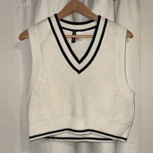 H&M white and black sweater vest. Cropped right at the hip line.